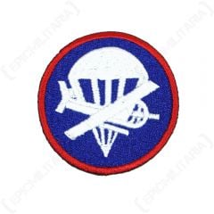 Circular Officers Airborne Garrison Cap Patch showing a plane and parachute in white on blue background, with red outline running around the outer of the badge