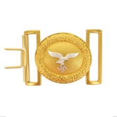 Front view of oval-shaped gold belt buckle with silver eagle in the middle