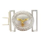 Front view of oval shaped silver belt buckle with golden eagle in the middle