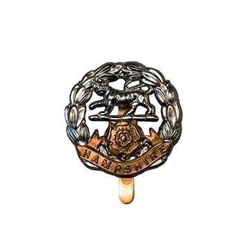 This image shows the front of the Hampshire Regiment Cap Badge. -TN