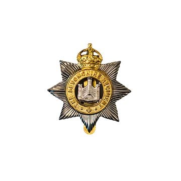 This image shows the front of the Devonshire Regiment Cap Badge. -TN