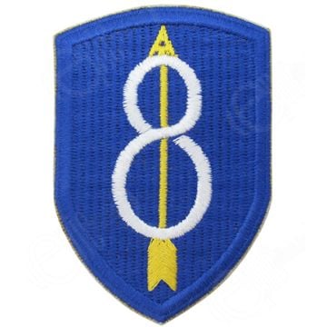 Blue shield shaped embroidered insignia with white 8 in the middle and a yellow upward arrow through the middle of the 8 - 8th Infantry Division