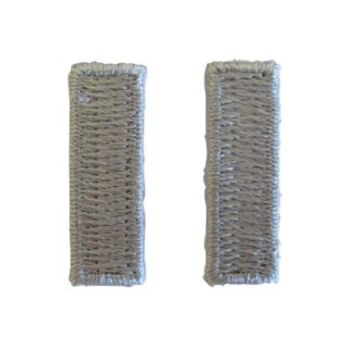 Front of pair of grey silver coloured, woven, horizontal First Lieutenant Officer Rank insignia