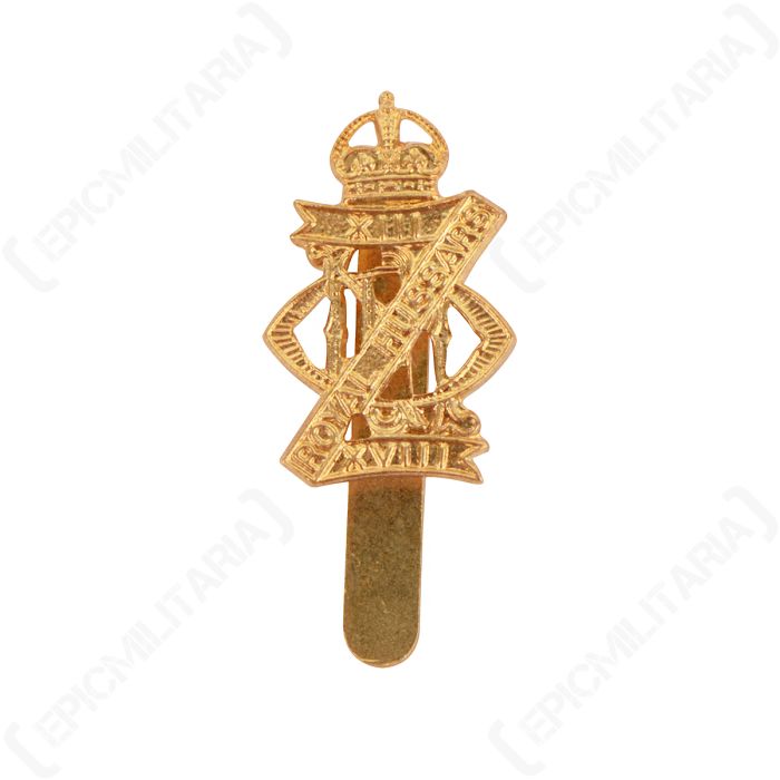 Front of gold-coloured badge of the British 13th/18th Hussars Regiment featuring a crown and banner with "XIII ROYAL HUSSARS XVIII"