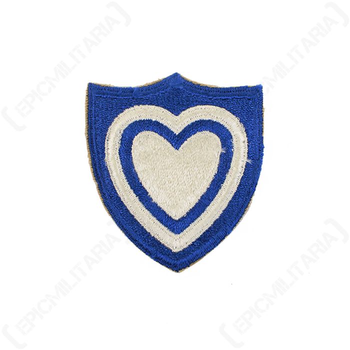 Front view of blue shield-shaped embroidered patch with white heard detail in the middle
