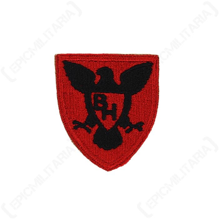 Front view of red shield-shaped embroidered patch with a black hawk in the centre, with the initials 'BH' in the middle