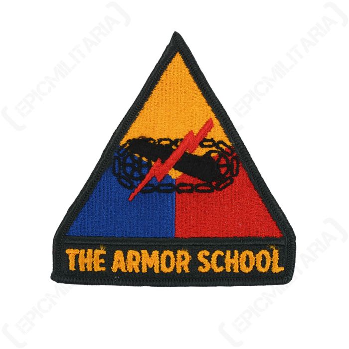 Front of embroidered triangular patch, with "THE ARMOR SCHOOL" in gold on a dark green background. The main body of the badge is yellow, red, and blue, and features a black cannon with red lightning flash in the middle
