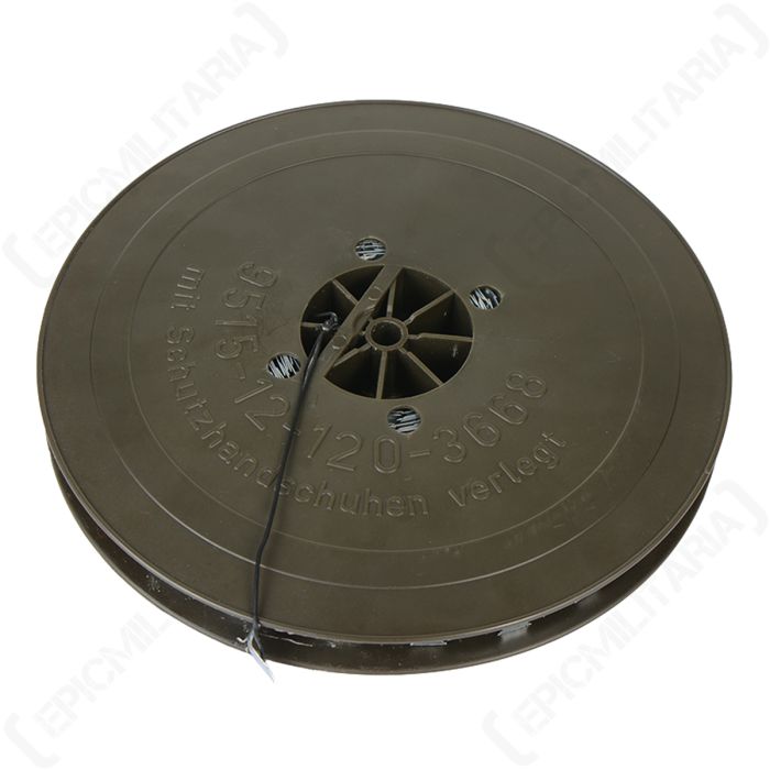 Top down view of circular plastic olive green reel containing razor wire