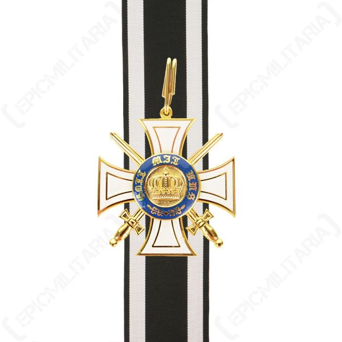 Front of white and gold cross-shaped medal on top of black and white ribbon