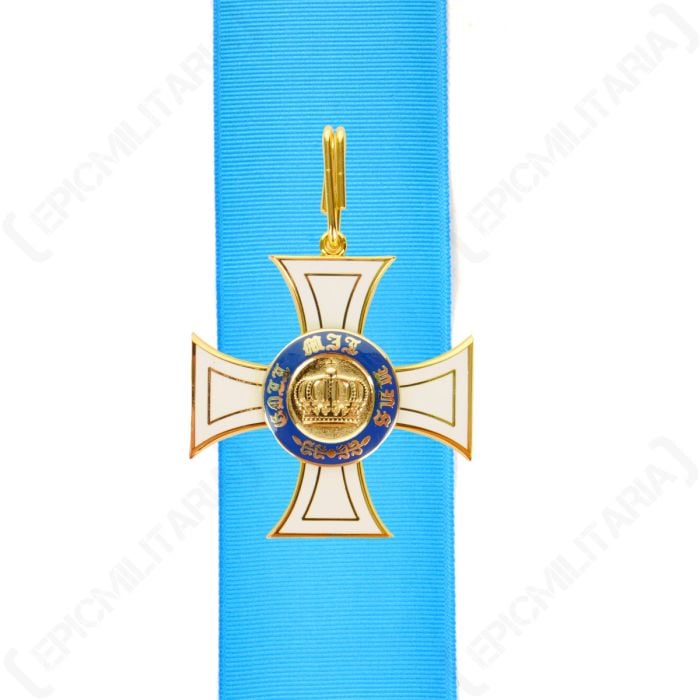 Front view of white and gold cross-shaped medal on top of blue ribbon