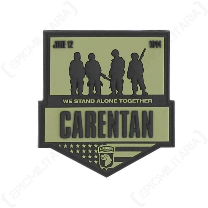 Green PVC patch with silhouettes of four soldiers with WE STAND ALONG CARENTAN in black in the middle