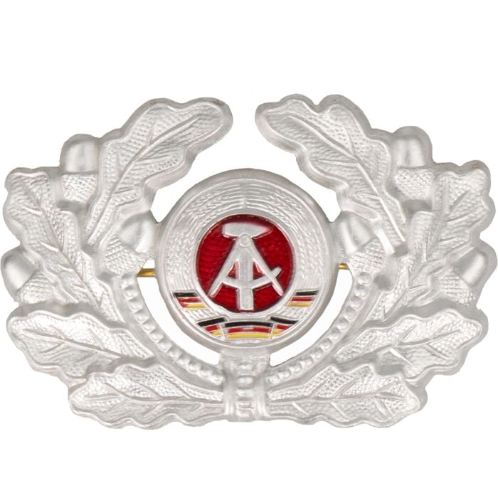 This view shows the front of the Original East German NVA DDR EM Cap Badge.