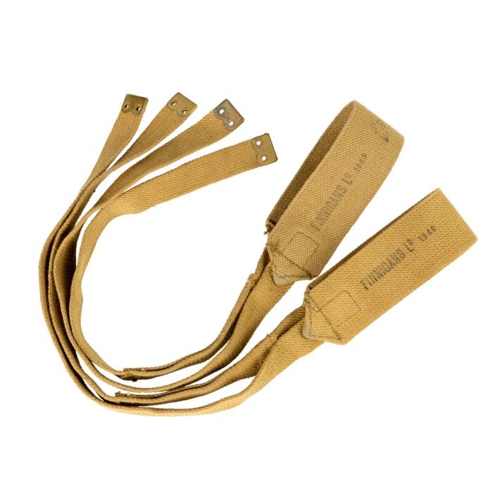 Pair of khaki straps with brass fittings laid in a curve on white background