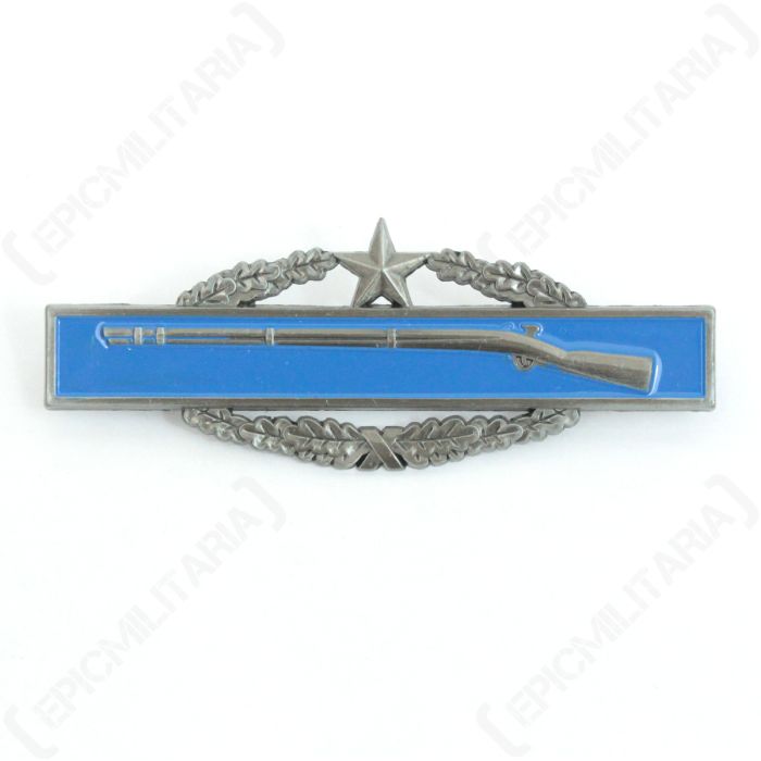 Front of Combat Infantryman 2nd Award, silver coloured rifle on horizontal blue rectangle, which is on top of a silver coloured wreath with a star at the top