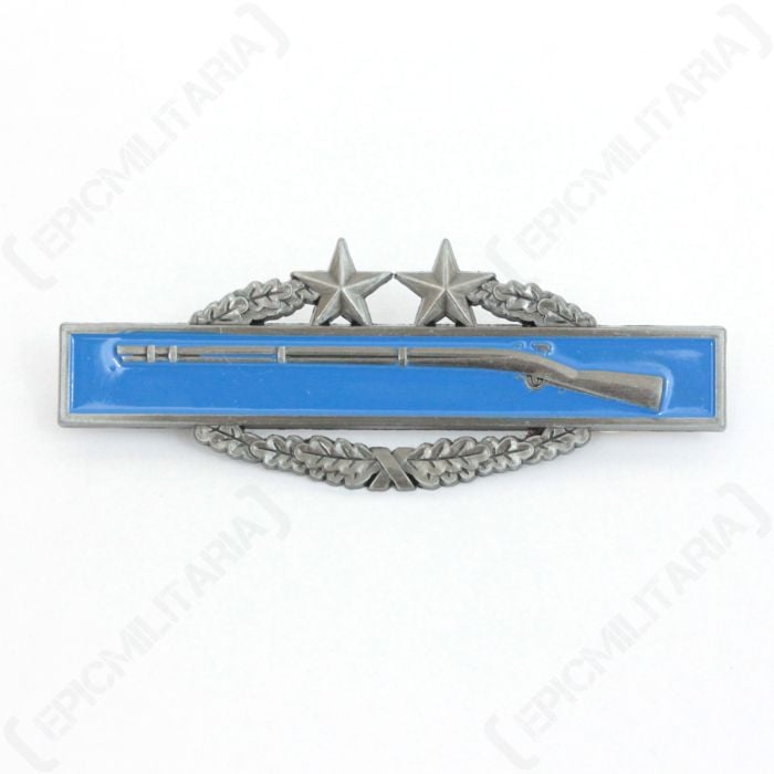 Front of Combat Infantryman 3rd Award showing right facing silver coloured rifle, on blue horizontal rectangular background, atop of a silver coloured wreath with two stars at the top
