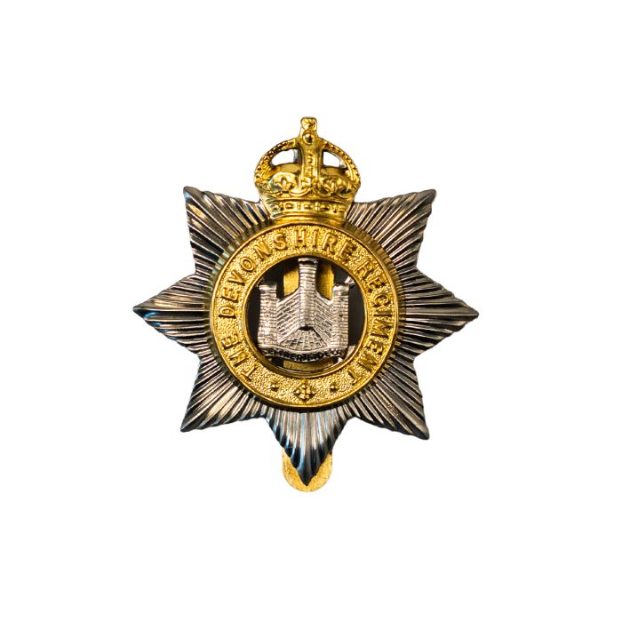 This image shows the front of the Devonshire Regiment Cap Badge.