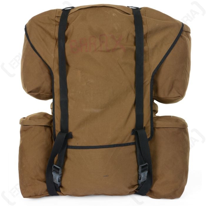 Front of brown canvas rucksack with two additional pouches on each side with two black canvas straps running vertically to secure the top flap shut