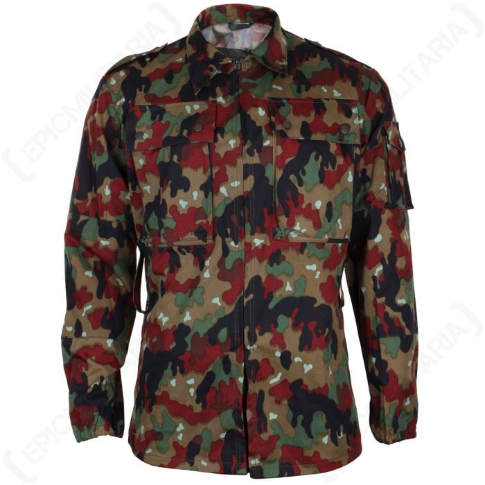Front view of M83 Swiss Camo field jacket made up of light brown, dark brown, green, and orange/rust brown leaf shapes. There are two large chest pockets with flaps and two brown popper buttons on each. The jacket is closed by a zipper up the front of the