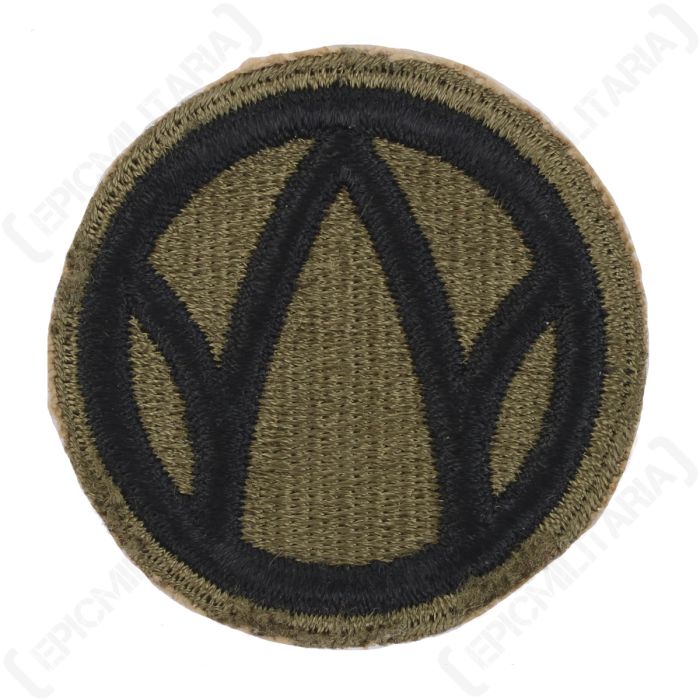 Front of embroidered green circle with a black 'W' in the middle, with a black ring