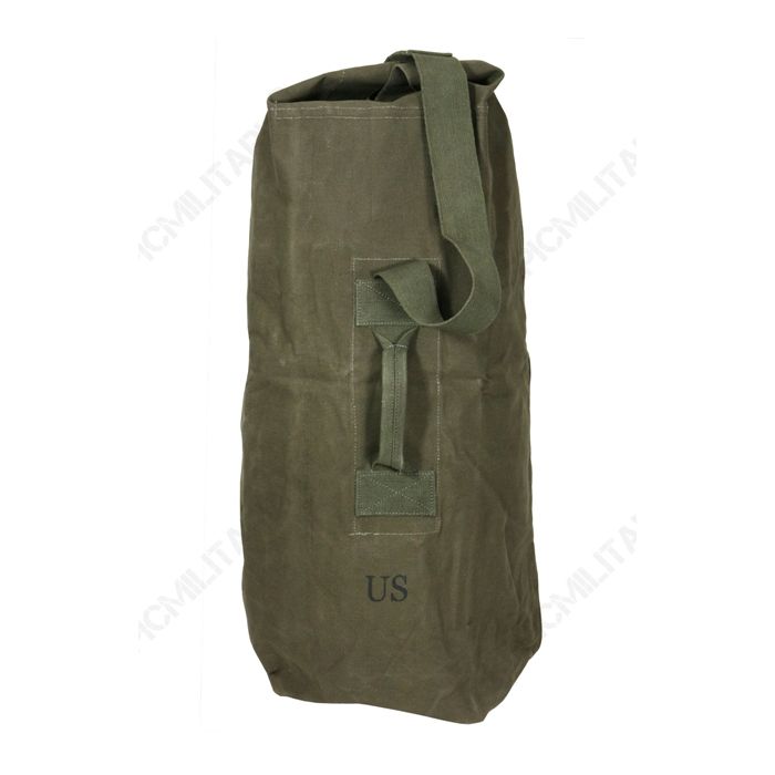 Front of olive green US Army upright duffel bag with green canvas strap and handle. US stamped underneath the handle.