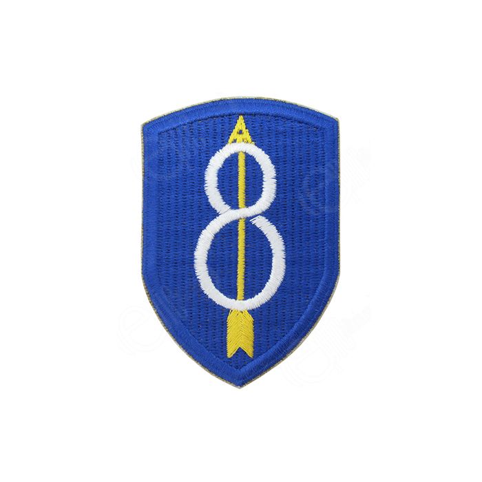 Blue shield shaped embroidered insignia with white 8 in the middle and a yellow upward arrow through the middle of the 8 - 8th Infantry Division