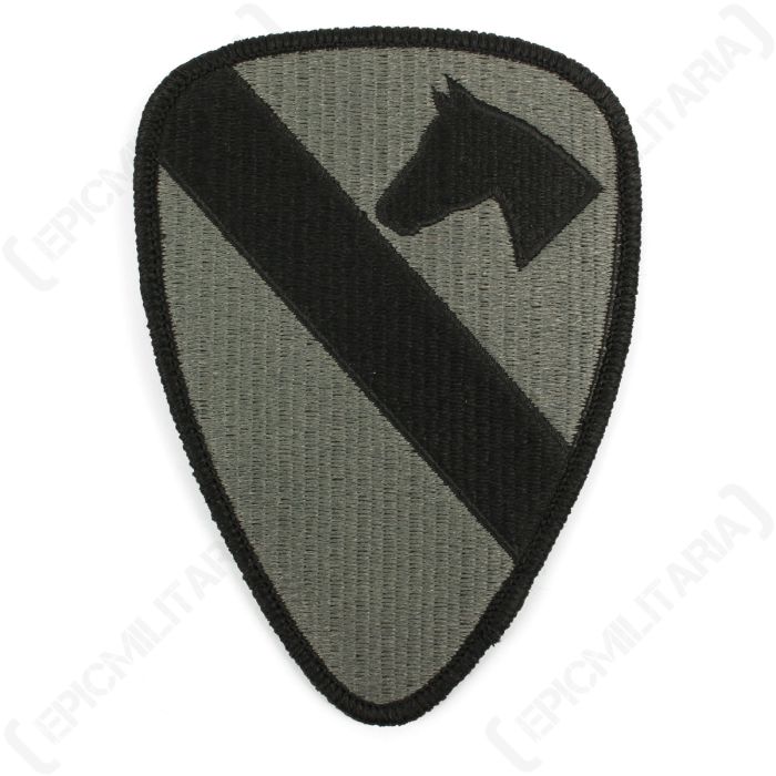 Shield shaped grey embroidered patch with black slash running from the top right corner to the bottom left side, and a black right-facing silhouette of a horse head