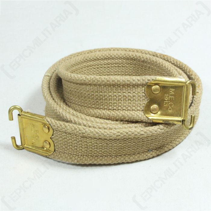 Rolled-up khaki-coloured canvas reproduction WW1 British Lee Enfield sling with brass-coloured ends