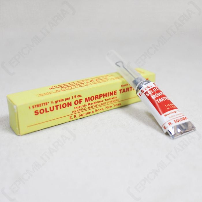 Front view of yellow WW2 US Medic Morphine Tartrate box with red text, with a tube of Morphine Tartrate leaning on the end of the box
