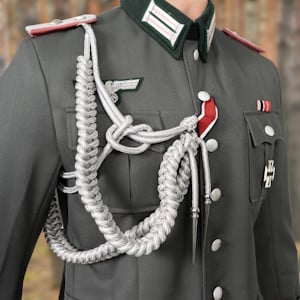 A close up of a german tunic showing various insignia and medals.