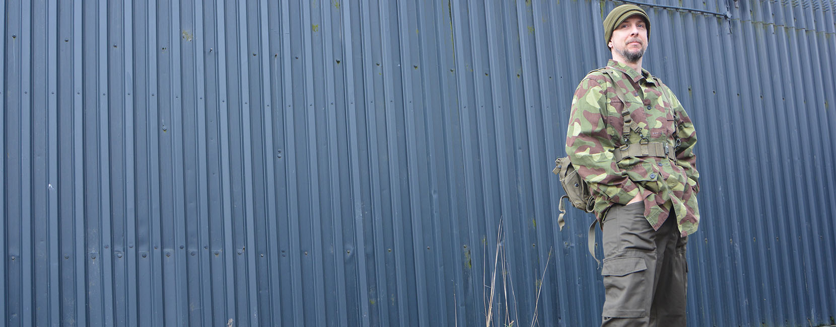 Person in front of a container wearing full military surplus clothing.