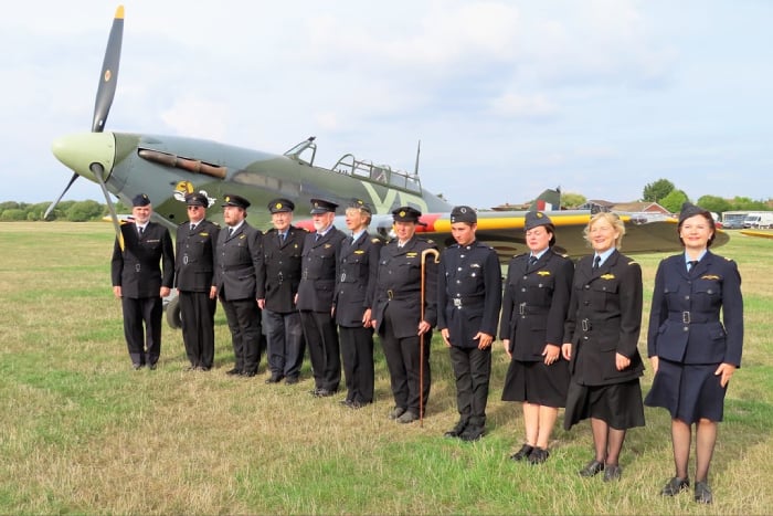 11 ATARG members on parade in front of a British Spitfire