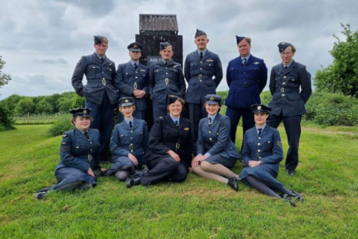 A Group poses on a hill wearing RAF uniforms